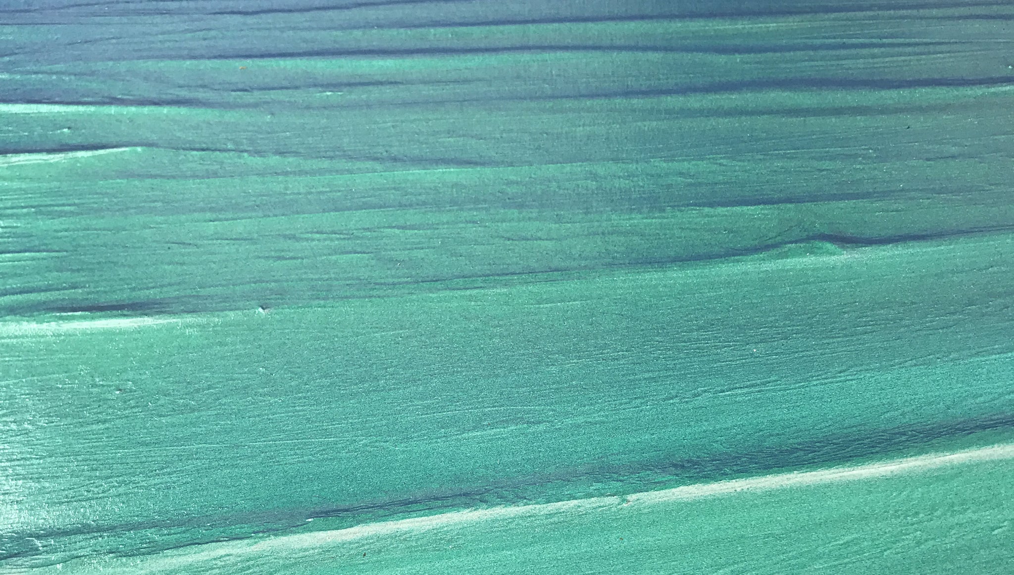 Close-up of a textured turquoise seascape painting by Carl West